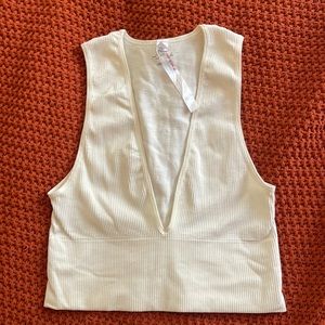 Out from under white ribbed crop top